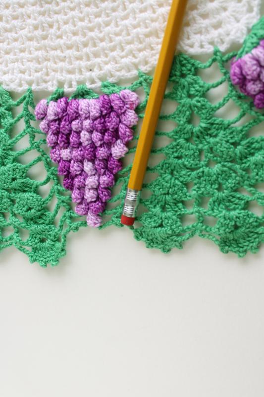 vintage crochet lace doily or lamp table mat, bunches of purple grapes
