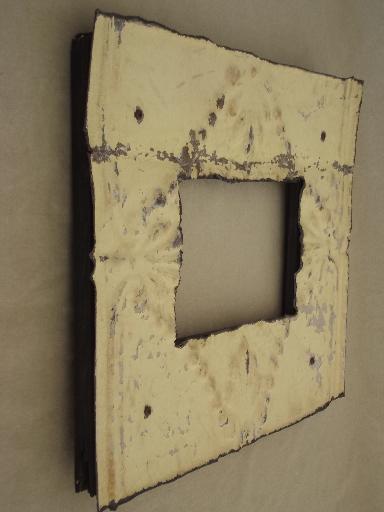 vintage metal frame made of embossed tin ceiling with shabby old paint
