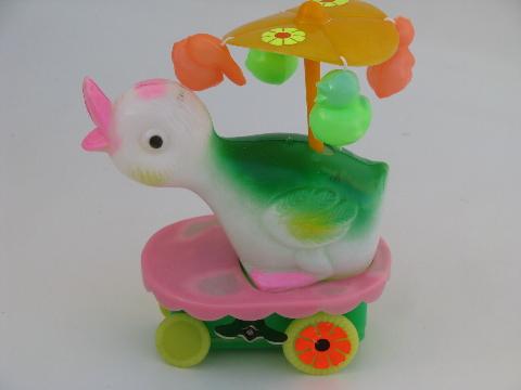 wind-up vintage Easter duck toy, merry-go-round parasol flower cart