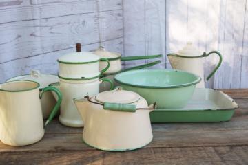 catalog photo of 1930s vintage cream & green enamelware pots & pans collection, very worn old kitchenware for display 