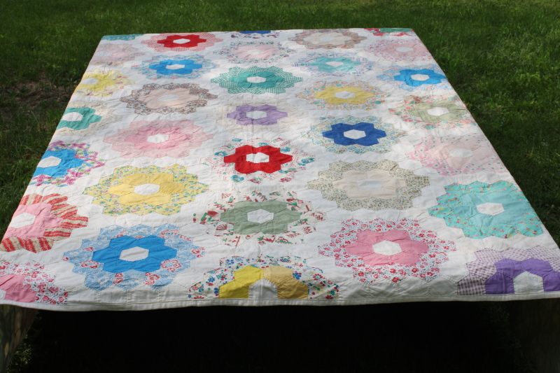 photo of 1940s 50s vintage grandma's flower garden quilt colorful cotton feed sack print hexies hand stitched quilting #1