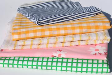 catalog photo of 60s 70s vintage fabric lot, retro prints in bright happy colors, pink, green, yellow, blue