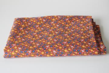 catalog photo of 70s vintage cotton calico fabric, floral print small blue & yellow flowers on tomato red 
