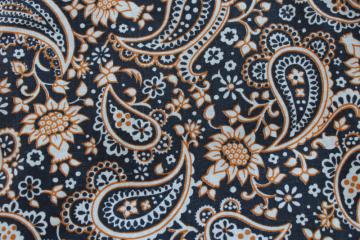 catalog photo of 70s vintage cotton canvas fabric, hippie bohemian paisley orange gold & black print