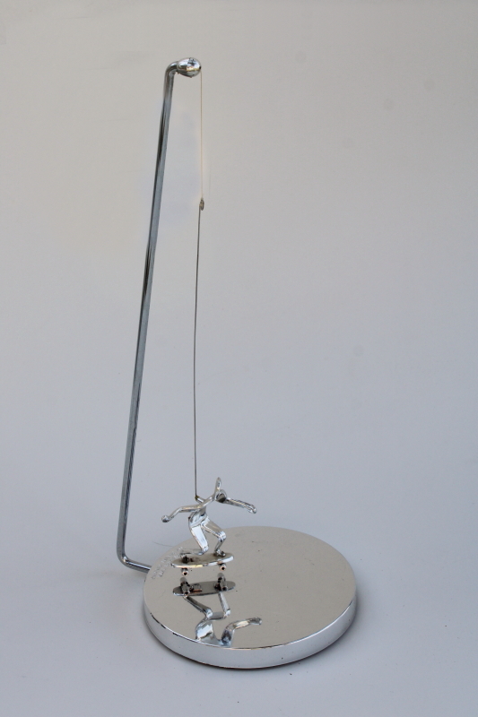 photo of 70s vintage kinetic sculpture, magnet pendulum perpetual motion skateboarder in mod chrome #1