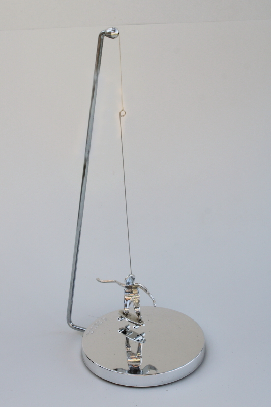 photo of 70s vintage kinetic sculpture, magnet pendulum perpetual motion skateboarder in mod chrome #2