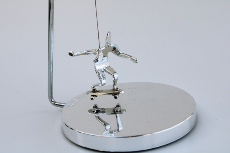 photo of 70s vintage kinetic sculpture, magnet pendulum perpetual motion skateboarder in mod chrome #3