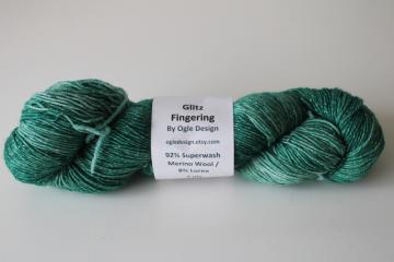 catalog photo of Glitz sock yarn 4 ounces superwash merino wool shades of green w/ lurex metallic thread 