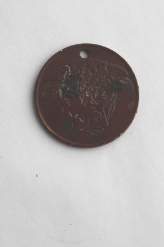 photo of Hereford's Whiskey You Pay token, tarnished copper color coin w/ Hereford cow or bull #1