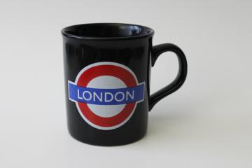 catalog photo of London souvenir coffee cup or tea mug, underground logo on black ceramic