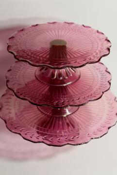 catalog photo of amethyst pink colored glass cake stands, scalloped edge laurel vines, tower of graduated sizes