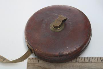 photo of antique Chesterman 100 foot cloth tape measure in leather case, brass hand crank winding reel