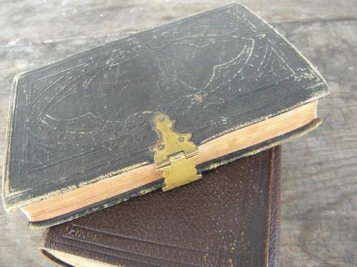 photo of antique bibles, 1800s pocket sized embossed leather covers,brass clasp #4