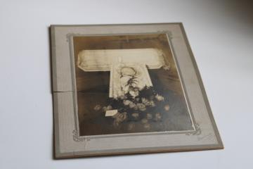 photo of antique cabinet card photo, baby in casket w/ flowers, vintage post mortem photo