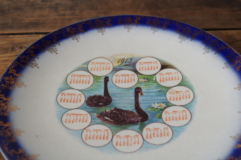 photo of antique calendar plate from 1913 Manawa Wisconsin, black swans w/ flow blue border, shabby stained china  #2