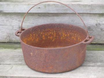 catalog photo of antique cast iron kettle, bean or stew pot for campfire and wood stove