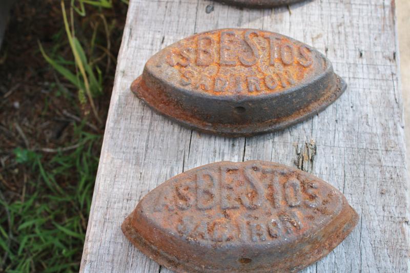 photo of antique cast iron sadirons, Asbestos brand irons, rusty junk primitive door stops #2