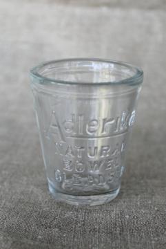 catalog photo of antique embossed measure glass medicine dose cup, Adlerika quack remedy bowel cure