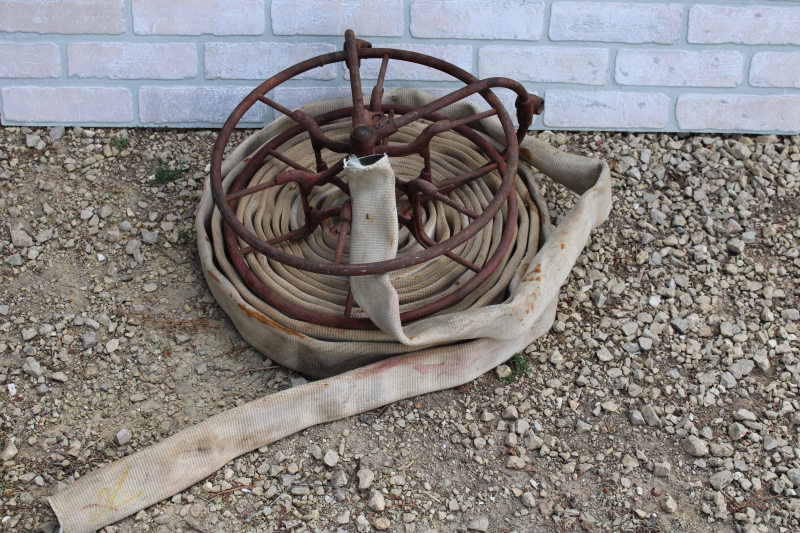 photo of antique fire hose reel, Wirt Knox cast iron wheel and mounting rack w/ Captain cotton rubber fire hose #5