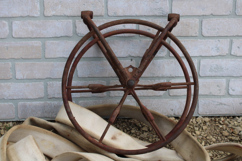 photo of antique fire hose reel, Wirt Knox cast iron wheel and mounting rack w/ Captain cotton rubber fire hose #7