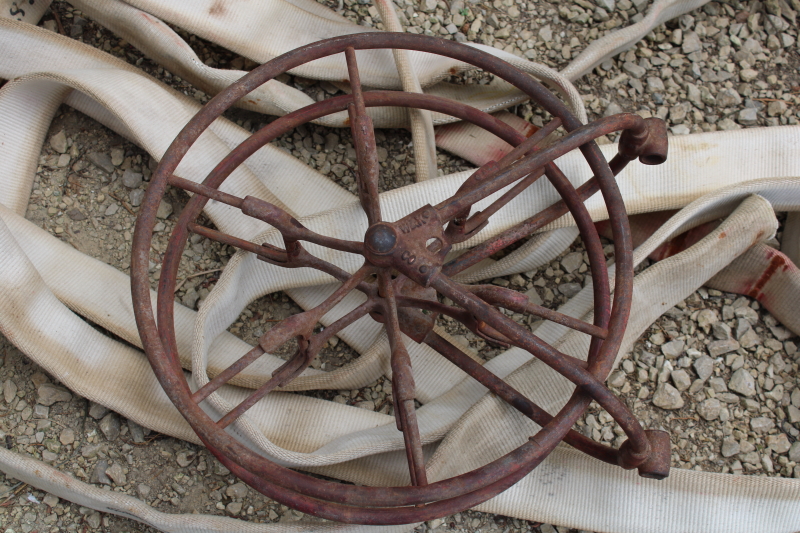 photo of antique fire hose reel, Wirt Knox cast iron wheel and mounting rack w/ Captain cotton rubber fire hose #10