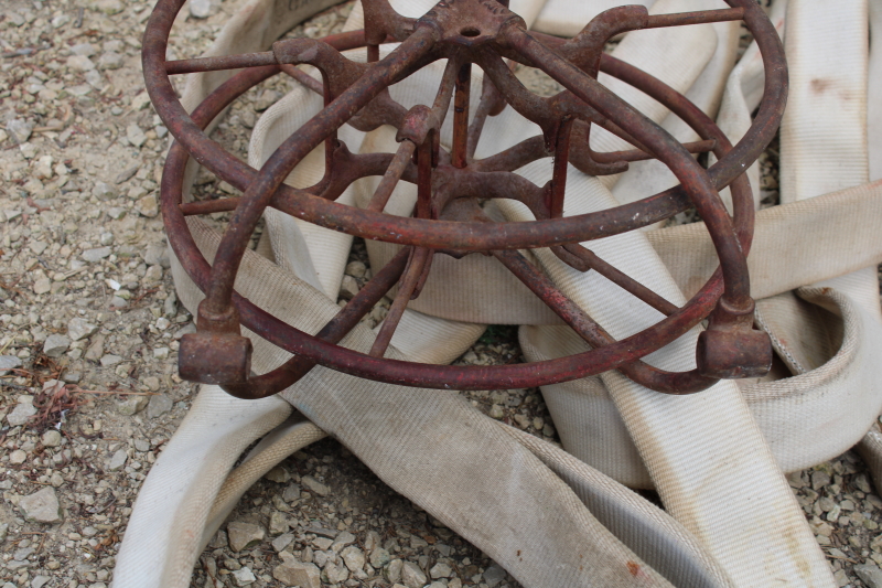 photo of antique fire hose reel, Wirt Knox cast iron wheel and mounting rack w/ Captain cotton rubber fire hose #11