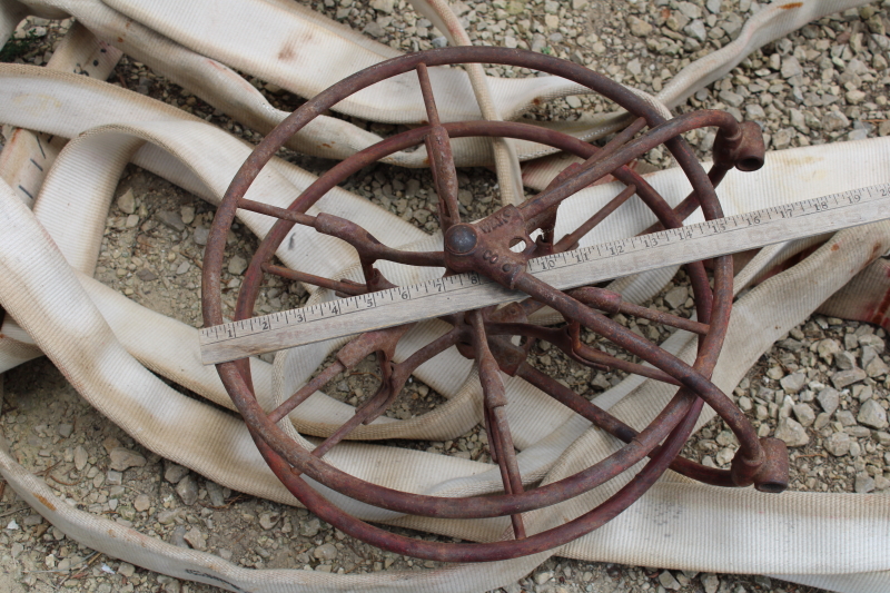 photo of antique fire hose reel, Wirt Knox cast iron wheel and mounting rack w/ Captain cotton rubber fire hose #12