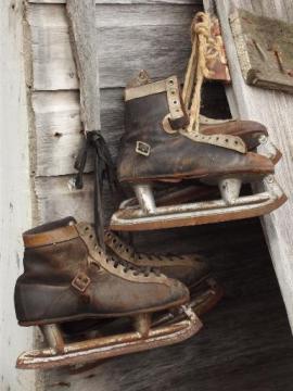 catalog photo of antique ice skates, vintage leather boots hockey skates for display