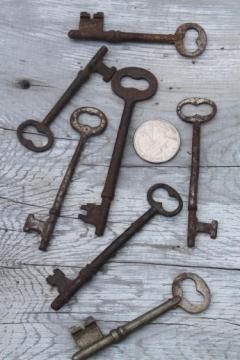 catalog photo of antique key collection, lot of vintage skeleton keys, gate keys, old door lock keys