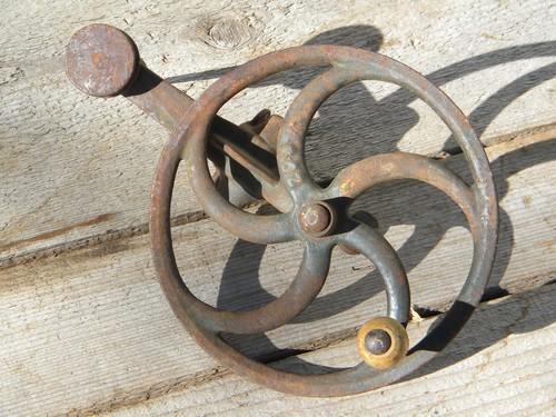 photo of antique primitive hand cranked tool spindle, /flywheel w/curved spokes #1