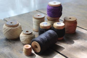 catalog photo of antique spools of sewing thread & wood spools w/ old cotton string, primitive style