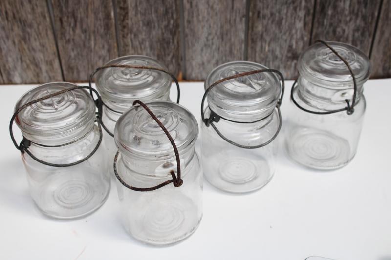 photo of antique vintage Ball Ideal Mason clear glass jars w/ wire bail lightning lids #8