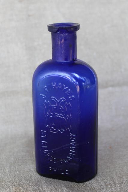 photo of antique vintage embossed glass medicine bottle St George's Pharmacy cobalt blue glass #1