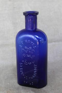 catalog photo of antique vintage embossed glass medicine bottle St George's Pharmacy cobalt blue glass