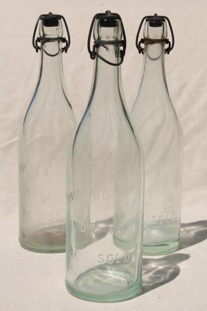 photo of antique & vintage glass bottles w/ wire bail lids, old embossed glass wine bottles #4