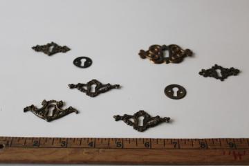 catalog photo of antique vintage solid brass hardware, lot of mixed escutcheons ornate keyholes