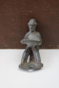 catalog photo of antique vintage toy cast metal man, tractor or truck driver? farmer or fireman 