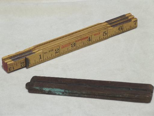 photo of antique wood measures, brass bound folding scales, old advertising tool rulers #1