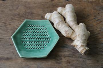catalog photo of artisan pottery green glaze grater for ginger or garlic, kitchen grate plate 