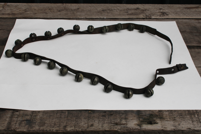 photo of authentic antique sleigh bells, silver tone brass bells on worn old leather strap horse harness  #1