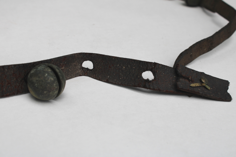 photo of authentic antique sleigh bells, silver tone brass bells on worn old leather strap horse harness #2