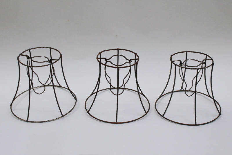 photo of bare wire lamp shade frames, trio of little bell shaped shades clip on bulb type chandelier light shades  #1