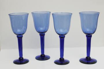catalog photo of big chunky hand blown glass goblets, cobalt blue water or wine glasses, rustic modern