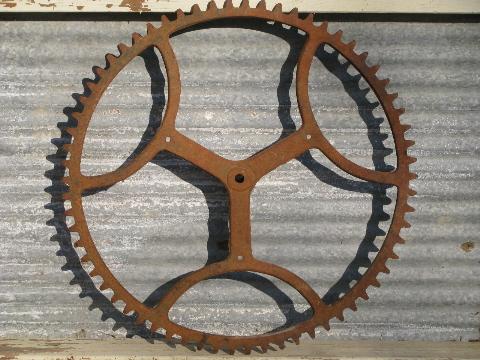 photo of big old antique forged iron toothed gear wheel, steampunk machine age #1