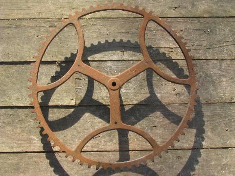 photo of big old antique forged iron toothed gear wheel, steampunk machine age #2