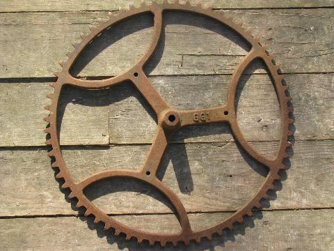 photo of big old antique forged iron toothed gear wheel, steampunk machine age #4