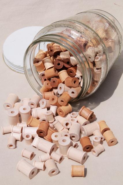 photo of big old herring barrel glass jar full of tiny wooden spools, wood spool lot #1