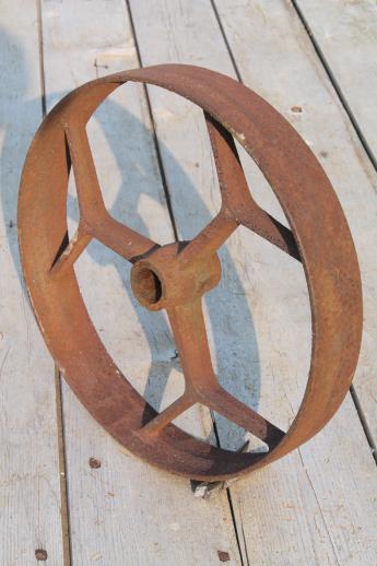 photo of big old iron fly wheel from steampunk vintage industrial machinery or farm equipment #1