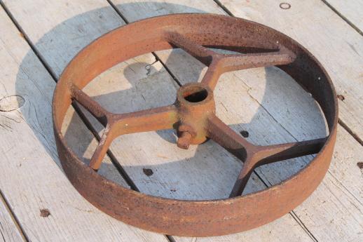 photo of big old iron fly wheel from steampunk vintage industrial machinery or farm equipment #2