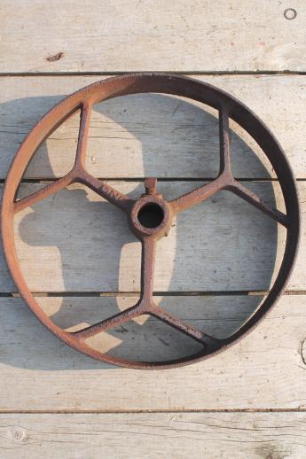 photo of big old iron fly wheel from steampunk vintage industrial machinery or farm equipment #5